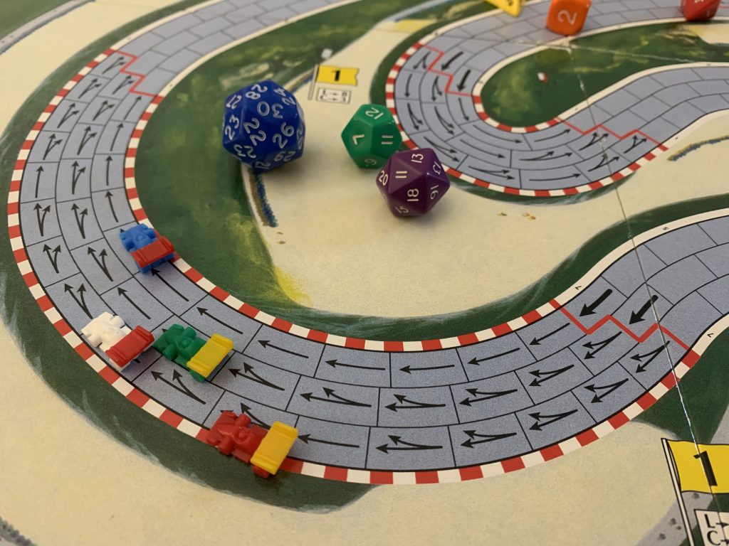 Illustrative photo of part of the racetrack used to play Formula D. Polyhedral dice sit in the bend.