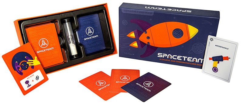 Photo showing box and contents for the physical version of Spaceteam. Two decks of cards sit alongside an egg timer.